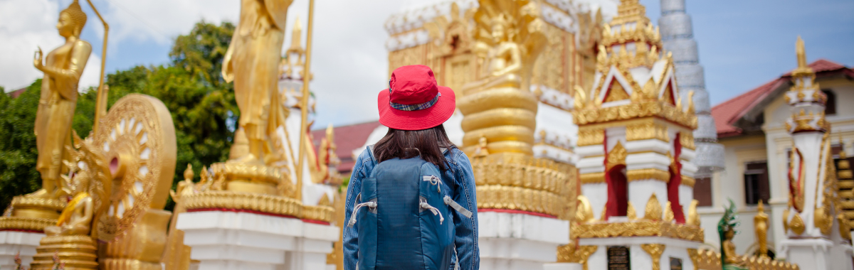 solo woman traveler infront of gold temple