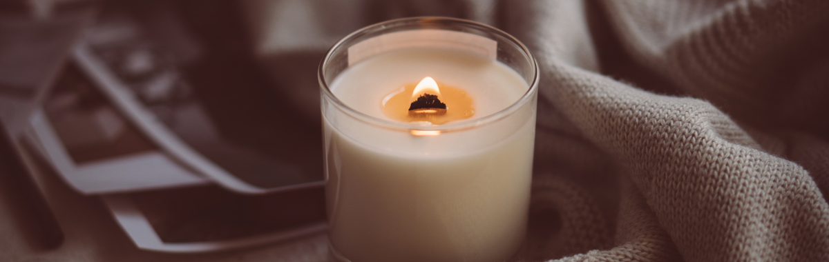 lit candle next to a cloth 