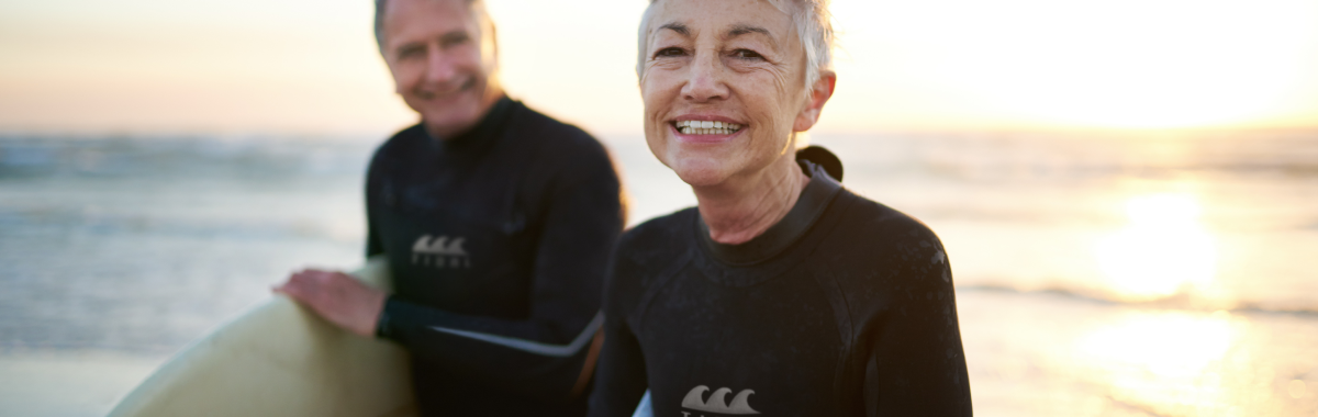 senior couple coming in from surfing