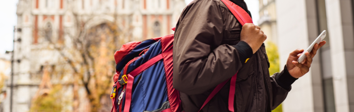 traveler with a backpack looking at their phone