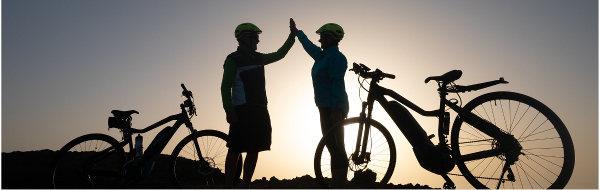 friends high fiving next to bikes