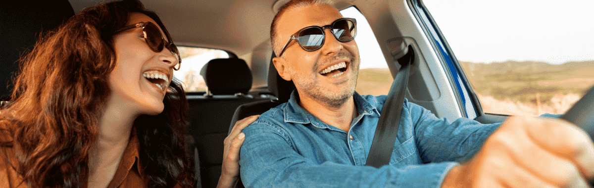 couple laughing and driving