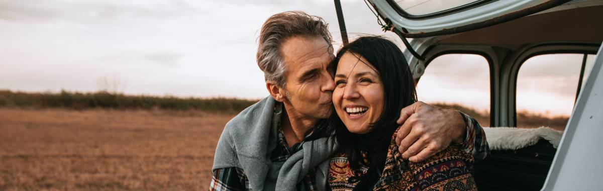 couple hanging out on back of car