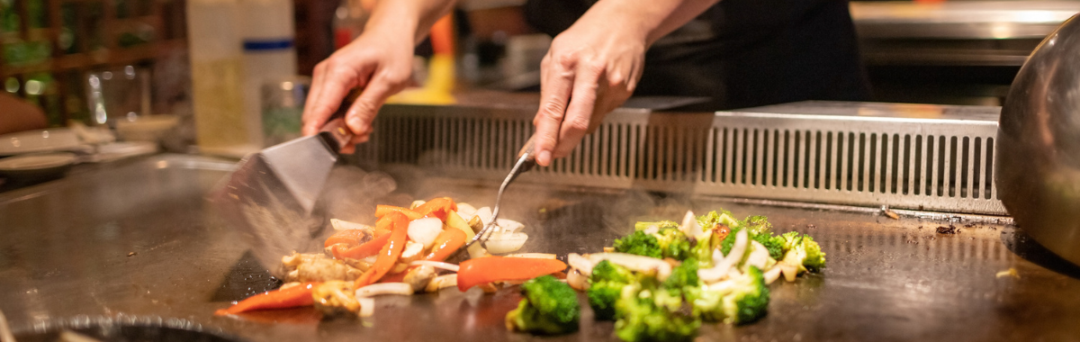 Japanese food being cooked on a gril