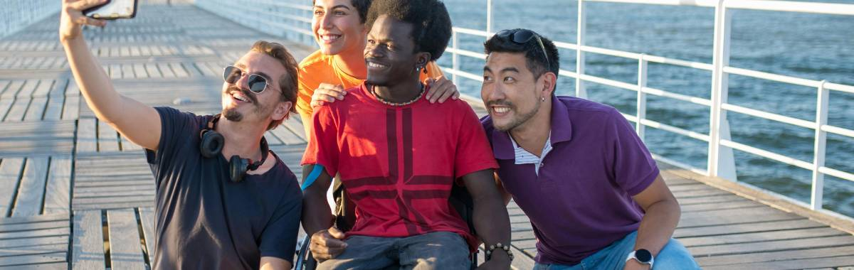 friends taking a selfie on a boardwalk