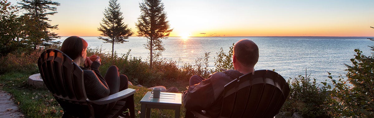friends gathered around a fire in the snow talking 