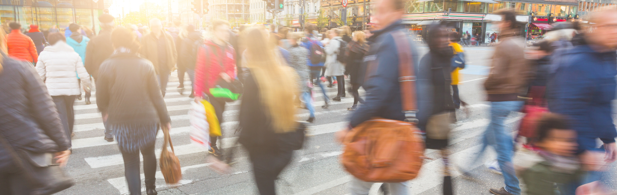 crowds of people walking through a town