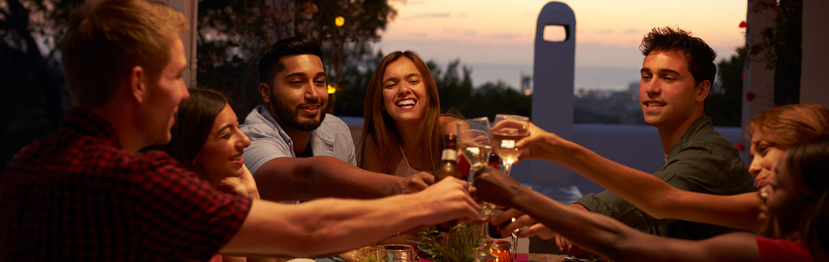 friends toasting over a table full of food