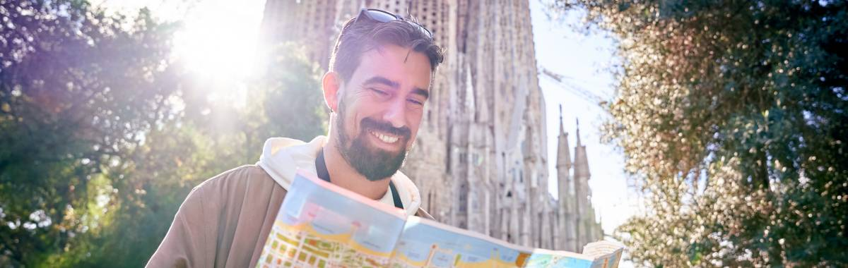 man smiling and looking at a map
