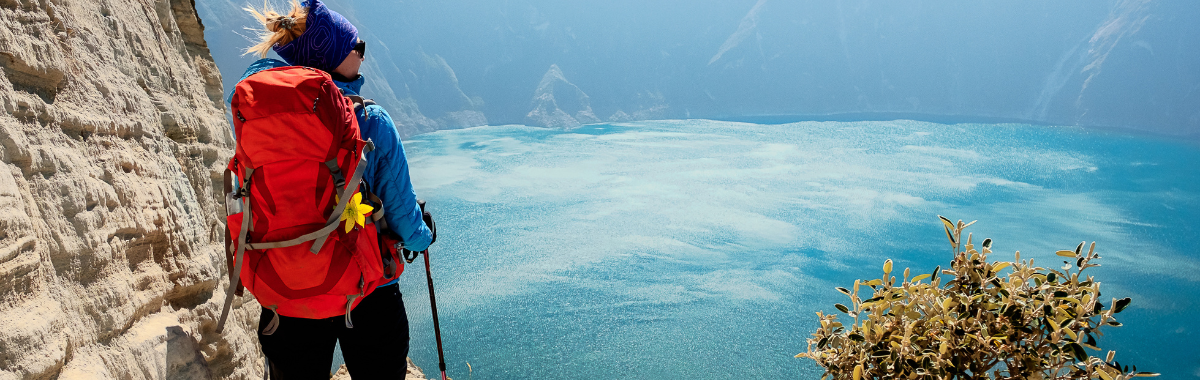 woman hiking with a red backpack
