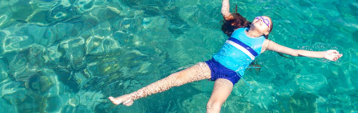 kid floating in a pool