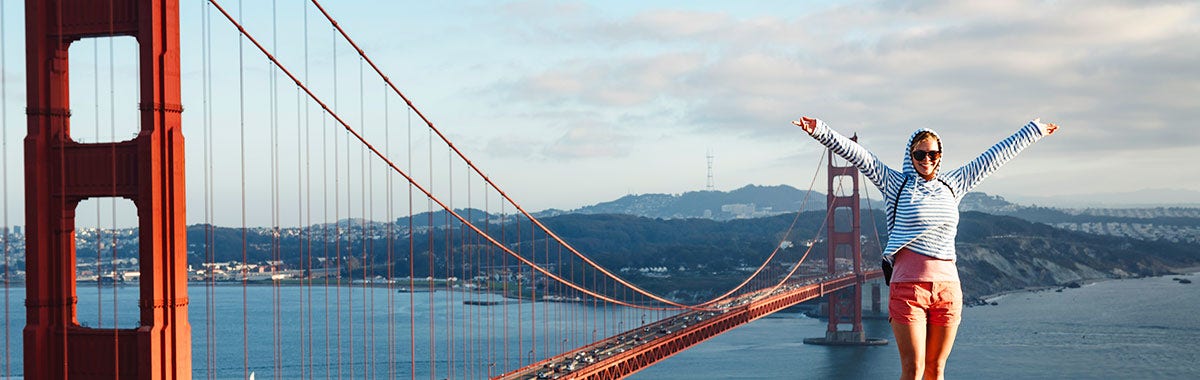woman posing next to the golden gate bridge