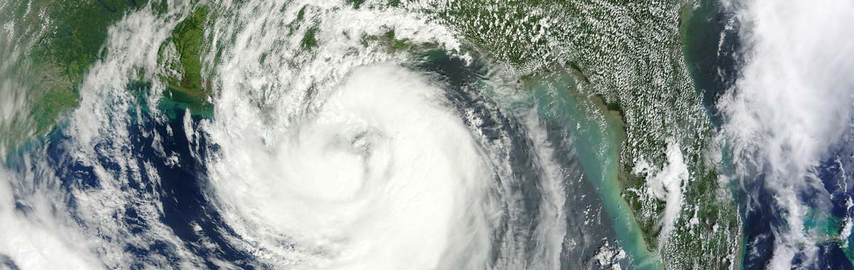 satellite view of a hurricane, an event that could be covered by vacation insurance