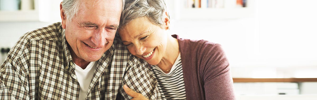 happy old couple hugging and smiling 