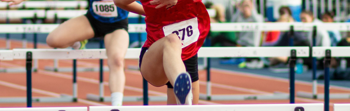 people jumping over hurdles 