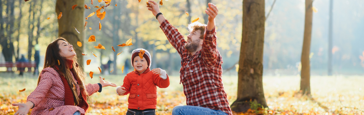 family playing in the leaves 