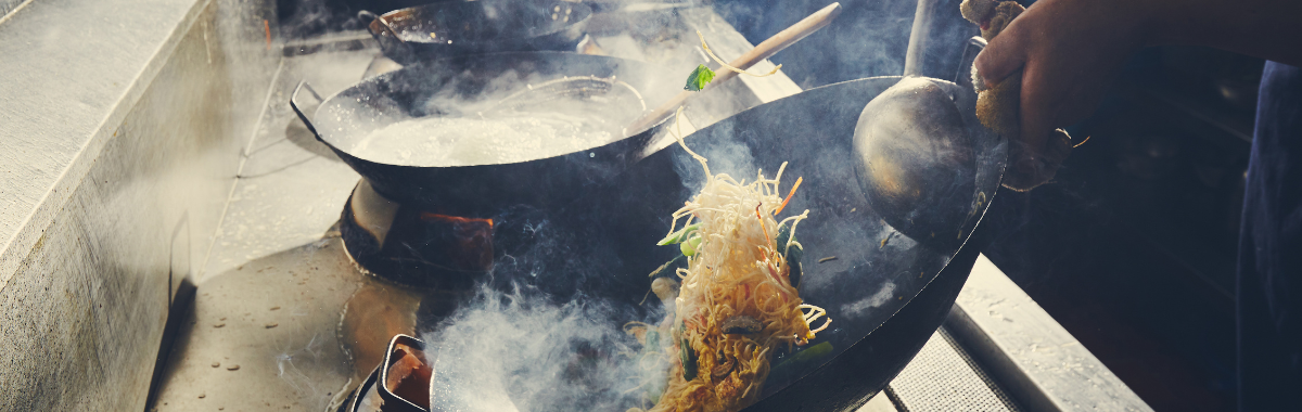 noodles being cooked in a Wok