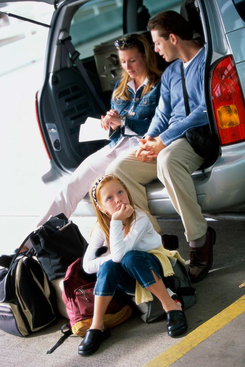family in car looking worried