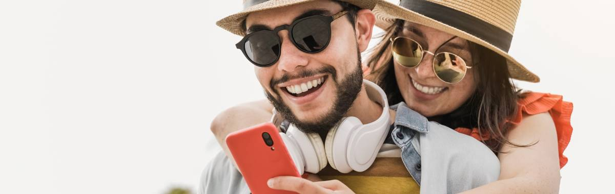 Millennial couple smiling looking at phone 