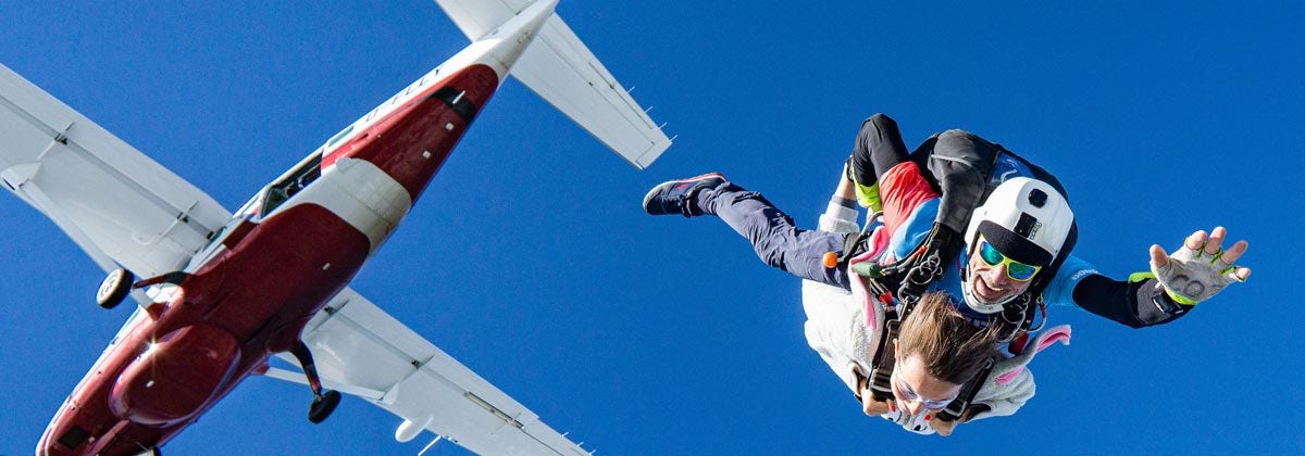 two skydivers and a plane