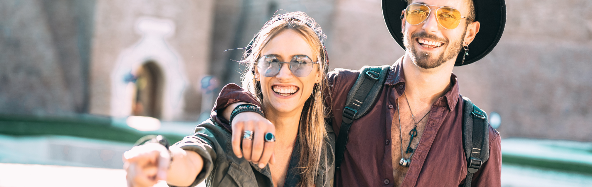 young travelers walking together pointing at something