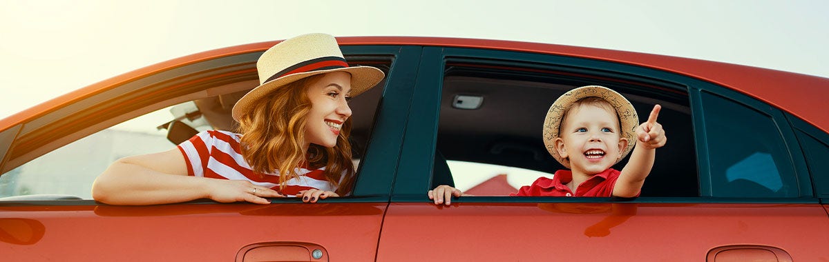 mother and son looking out of car window