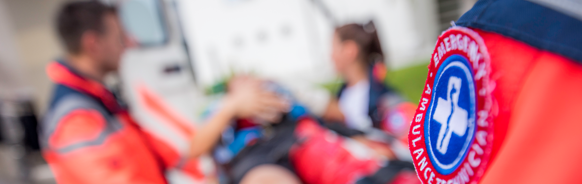 EMTs evacuating someone to an ambulance