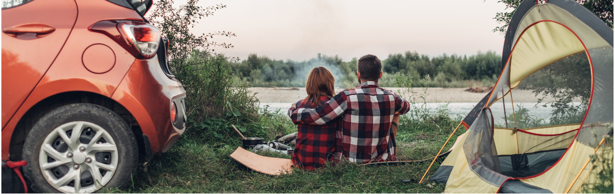 couple sitting together while camping