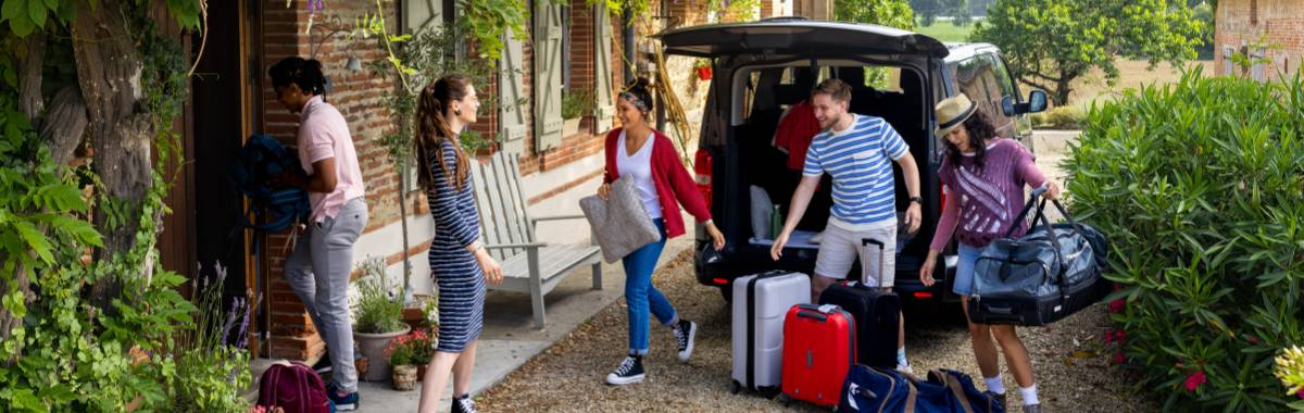 ranch with horses, trees and mountains in the distance