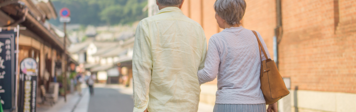 senior couple walking through a city