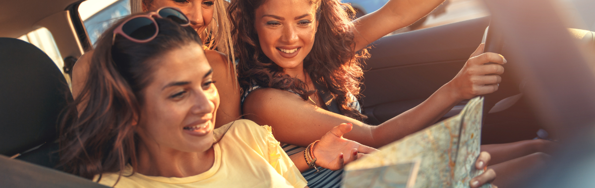 people looking at a map during a road trip