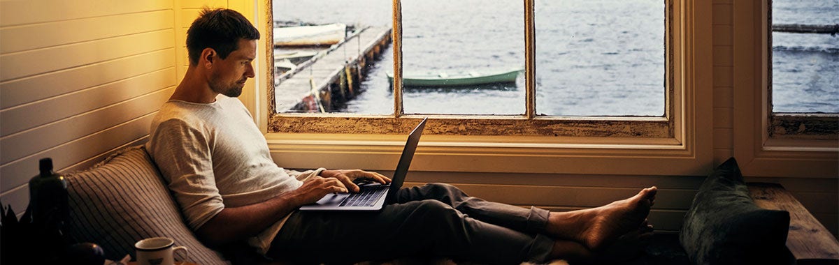 man on laptop on vacation