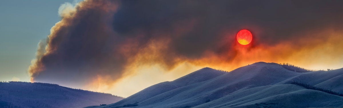 volcano with smoke rising out of it
