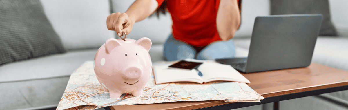 woman putting some money into a piggybank to save money