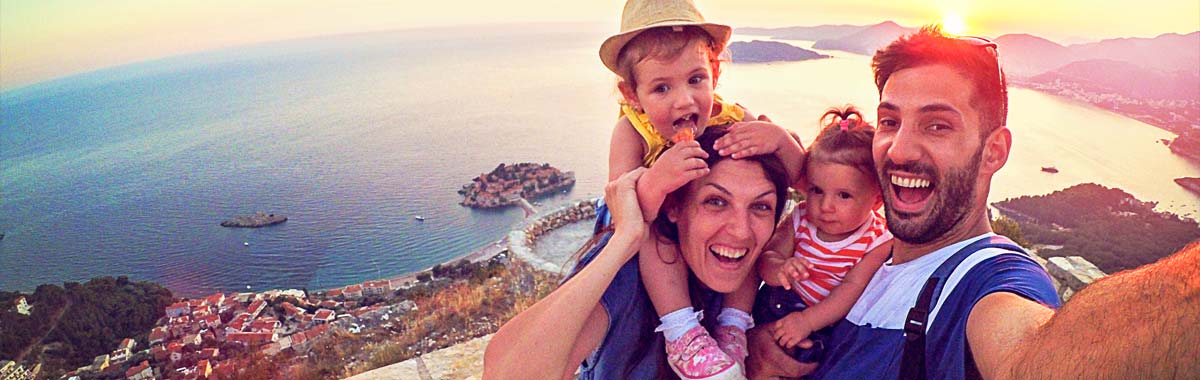 woman walking on a bridge away from an old historic castle