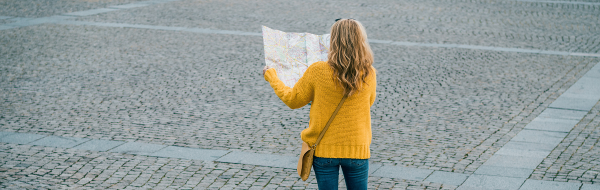 woman looking at a map in an empty plaza