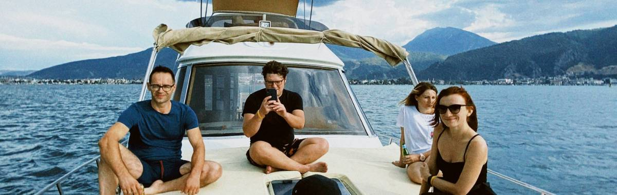 friends hanging out on the front of a boat