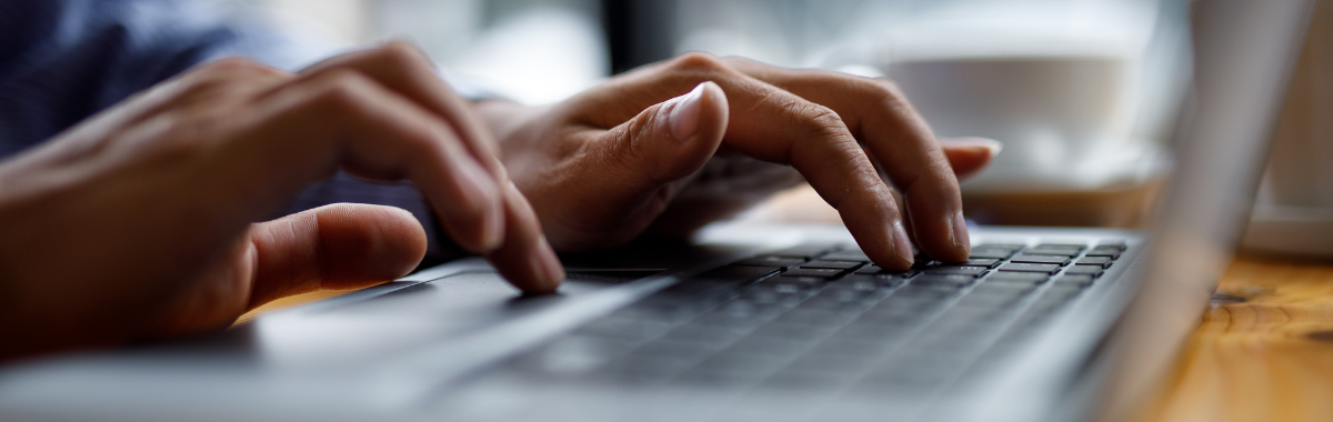someone typing on a laptop