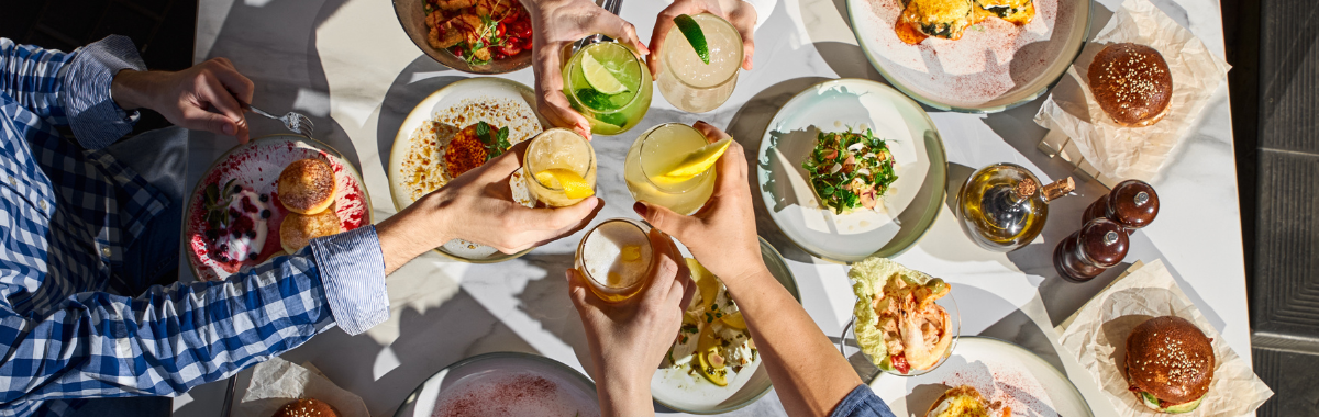 friends toasting over a table full of food