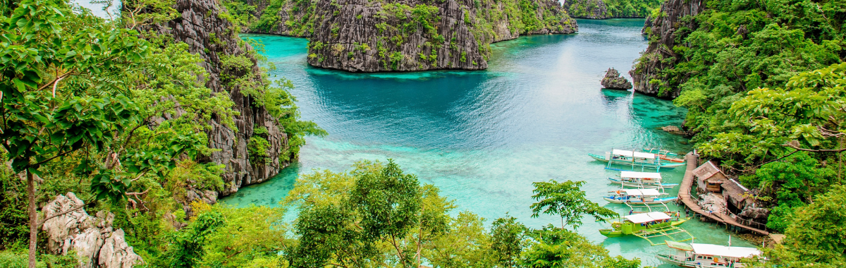 aerial shot of Palawans blue waters with some boats