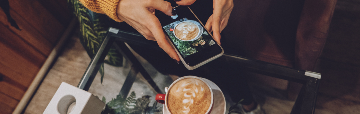person taking photo of their latte