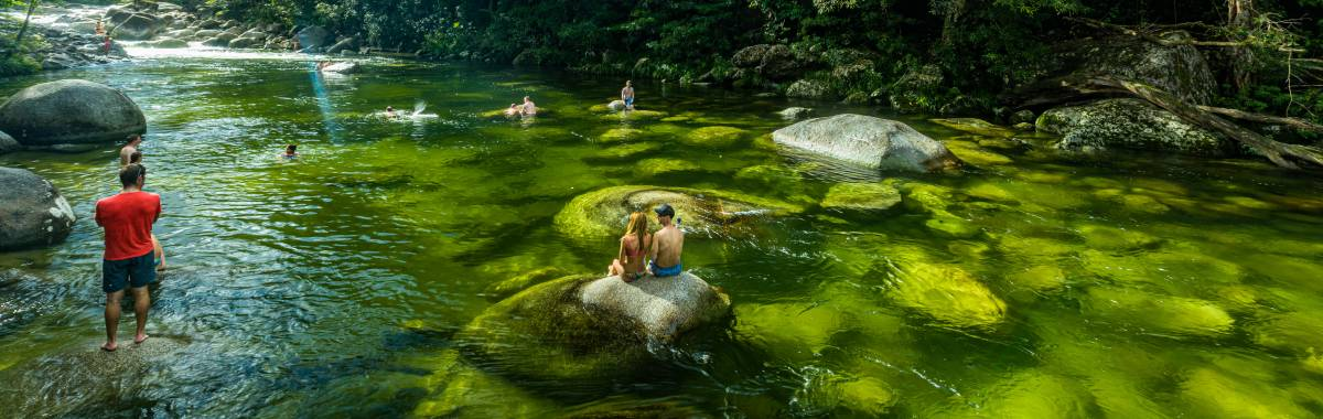 people swimming in a calm river