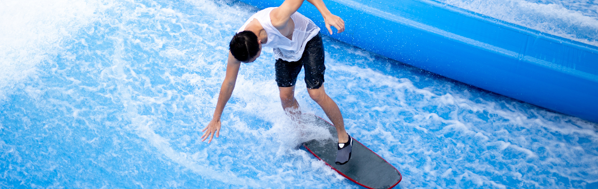 person on an indoor wakeboarding machine