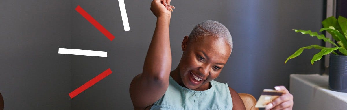 person celebrating with a credit card in hand