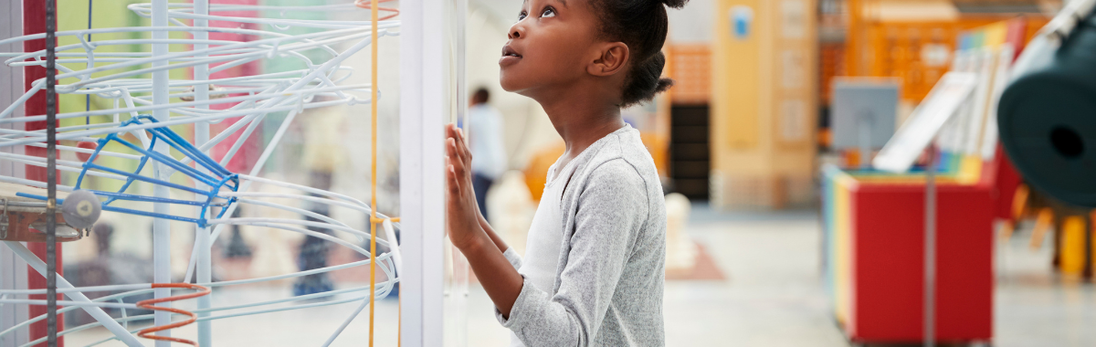 kid looking at contraption in a museum