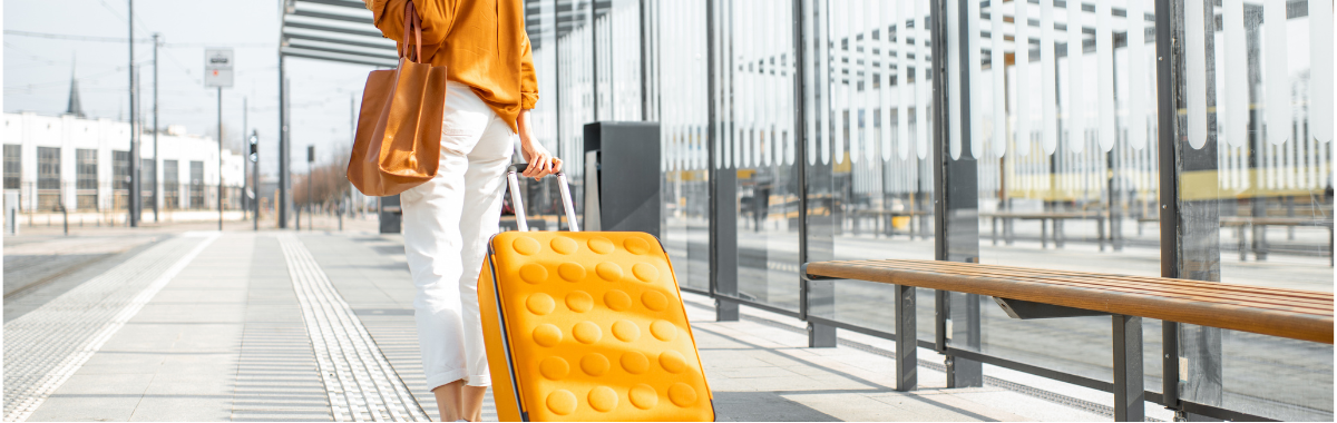 woman walking with her yellow suitcase 