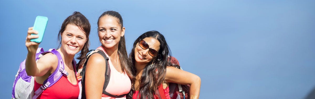 three women on a trip with backpacks