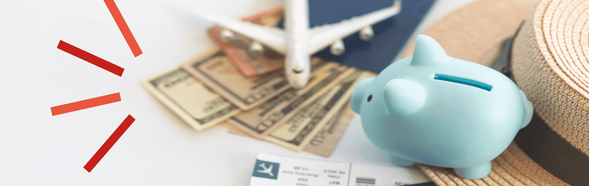 A toy airplane on top of some money next to a piggybank