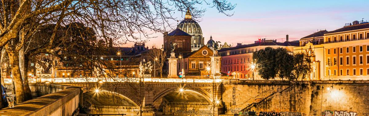 european bridge at night with lights all over it