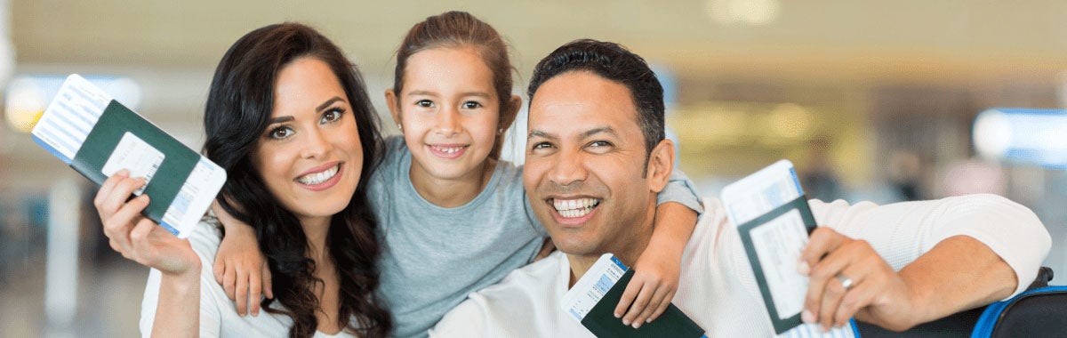 family smiling ready to travel